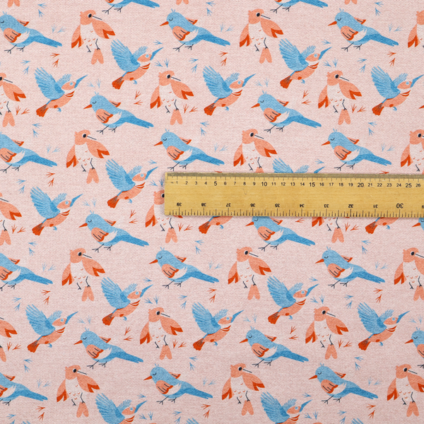 This fabric includes blue and pink birds in various positions on a soft pink background.