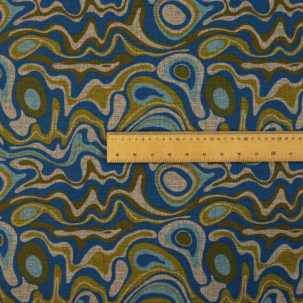 This fabric features different shades of green and beige swirls on a blue background.