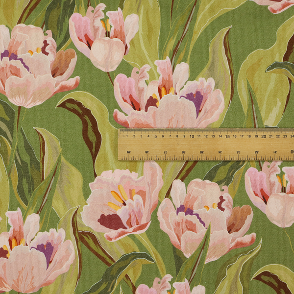 A lush, large-scale botanical pattern featuring soft-textured tulips and flowing green foliage in a romantic, painterly style across a solid green background.
