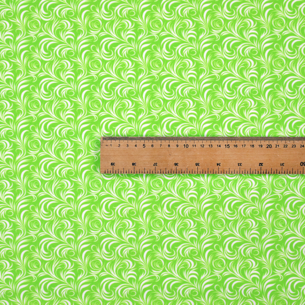 A vibrant, lime-green fabric featuring a dense, repeating pattern of elegant, white, swirling botanical motifs