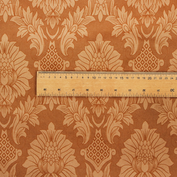 Warm brown damask fabric featuring a large-scale, repeating floral and acanthus leaf pattern in shimmering copper tones.