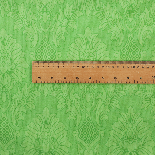 Vibrant apple green damask fabric featuring a repeating, large-scale floral medallion and acanthus leaf pattern in a tonal monochromatic colourway.