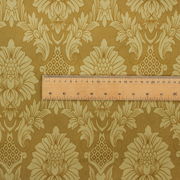 High-contrast damask fabric featuring a shimmering champagne-gold floral medallion pattern over a matte antique bronze background.