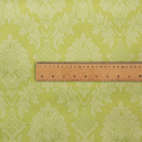 Bright lime-yellow damask fabric featuring a repeating, large-scale floral medallion pattern in a soft tonal colourway.