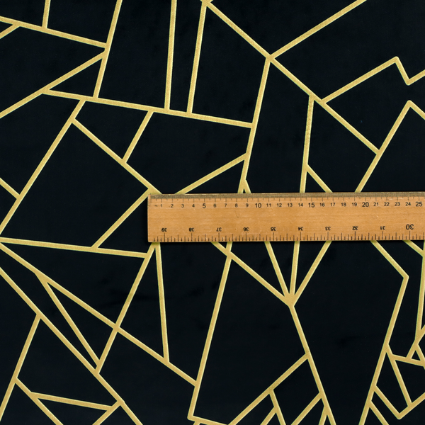 A close-up of a high-contrast black and gold fabric featuring a fractured, geometric mosaic design. The deep, matte black background is intersected by a network of sharp, metallic gold lines that form irregular, angular polygons. The pattern resembles a web of shimmering gold veins or a stylized shattered-glass effect, giving the textile a luxurious, Art Deco-inspired aesthetic.