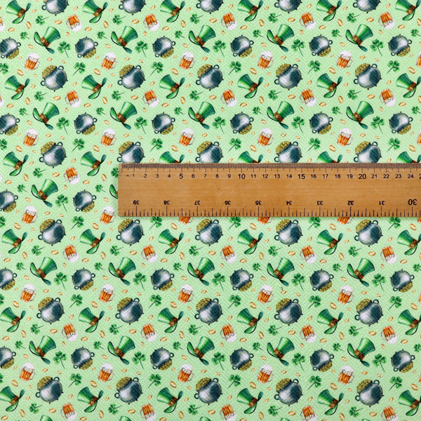 High-detail St. Patrick's Day fabric pattern on a light green textured background. The print features iron cauldrons overflowing with gold coins, frothy beer mugs, green leprechaun top hats with gold buckles, and scattered four-leaf clovers.