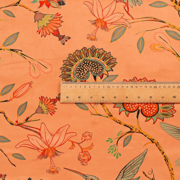 A vibrant botanical fabric pattern featuring detailed hummingbirds in flight among lush tropical flowers.