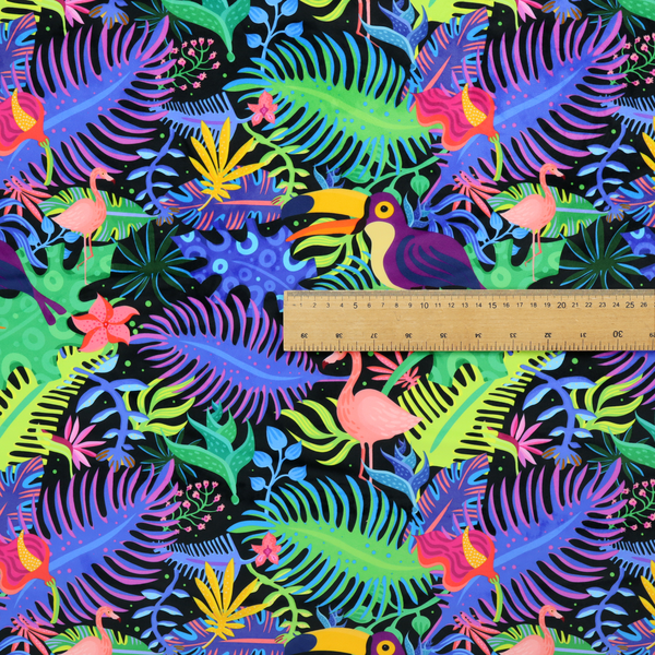A vibrant, tropical-themed fabric print featuring a dense pattern of colourful toucans, flamingos, and lush jungle leaves against a black background. The design incorporates bright neon hues of pink, purple, lime green, and yellow, creating a bold, exotic, and high-energy aesthetic.
