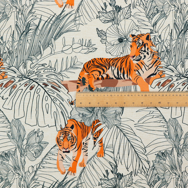 This fabric features a repeating botanical and wildlife pattern set against a light cream and grey background. The design showcases tigers in two poses—some walking and some resting—interspersed with detailed line drawings of large tropical leaves and hibiscus flowers.