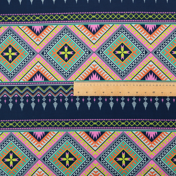 A vibrant, repeating geometric Aztec or tribal fabric pattern organized in horizontal bands. The design features alternating wide stripes of colourful diamond and zigzag motifs against narrower dark navy bands filled with intricate chevron and tassel-like embroidery accents.