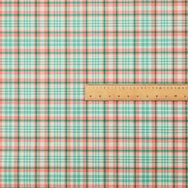 This fabric features a woven plaid pattern with a grid of intersecting horizontal and vertical stripes in coral, aqua, and dark green over a cream-colored background.