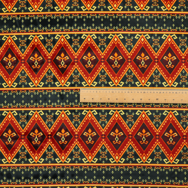 A fabric print featuring a repeating Southwestern geometric pattern. The design consists of horizontal bands with large red, orange, and yellow diamond motifs mixed with thin charcoal black borders detailed with small, delicate yellow tribal symbols.