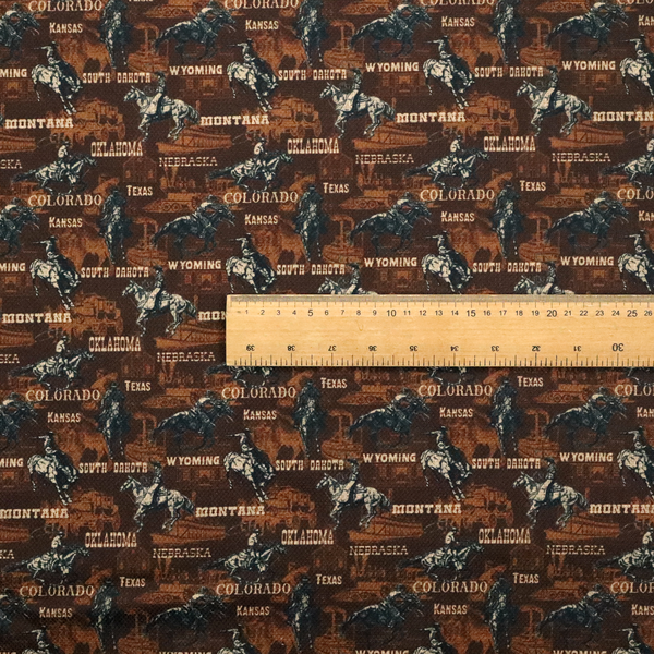 A dark, moody, repeating western tapestry pattern featuring realistic, vintage-style illustrations of cowboys on horseback, set against a deeply textured dark brown background. The palette relies on rich chocolate brown, earthy terracotta tones, and contrast details in cream and muted slate blue.