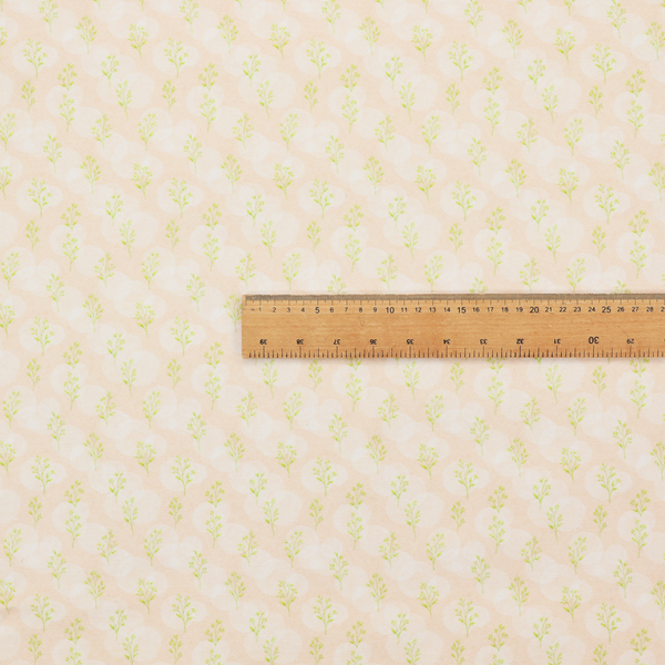 A soft watercolour design. The background consists of a subtle pastel peach wash layered with faint, painterly off-white circular polka dots. Arranged in neat diagonal rows over the circles are miniature, light lime green botanical sprigs and fine leaf stems.