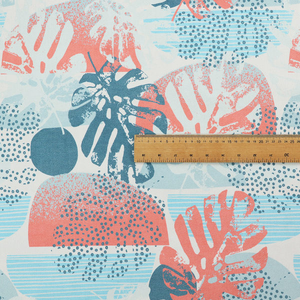 Abstract tropical fabric pattern featuring monstera leaf silhouettes and mid-century geometric shapes in coral, teal, aqua, and cream.