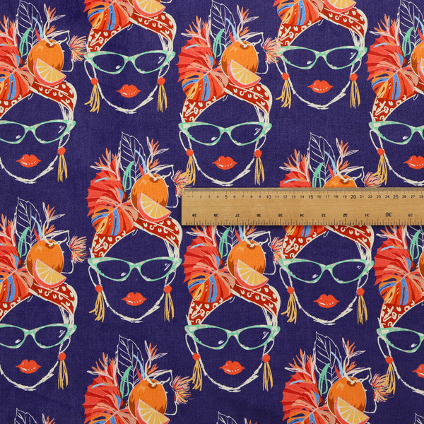 A repeating pattern on dark purple fabric featuring stylized line-art faces of women wearing light green cat-eye sunglasses, bright red lipstick, and elaborate tropical headwraps adorned with orange slices and palm leaves.