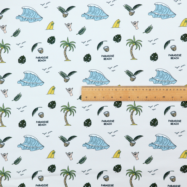 A playful pattern of ocean waves, palm trees, surfboards, and tropical leaves on a light background.