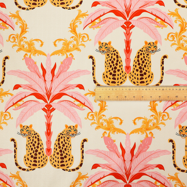 A repeating, symmetrical tropical toile pattern featuring leopards, pink palm trees, and ornate gold scrollwork against a cream background.