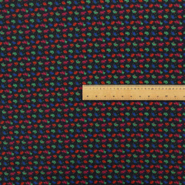 A textured tweed-style fabric featuring a dark background interwoven with dense specks of vibrant red, green, and blue flecks.