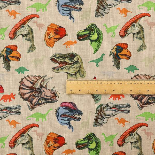 Several distinct dinosaur heads are scattered across the pattern, including detailed illustrations of a Triceratops with horns, a green Tyrannosaurus rex with textured skin, a long-snouted Parasaurolophus with a prominent crest, a blue-headed theropod with a pink crest, an orange-headed ceratopsian, and a Spinosaurus with a crocodile-like snout.