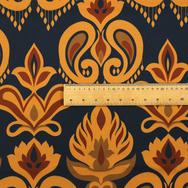 Close-up of a decorative upholstery fabric with a repeating Ikat-style floral motif. The colour palette consists of Mustard Gold, Rust, and Earthy Brown on a Midnight Black woven base, featuring stylized teardrop swirls and geometric petal patterns.