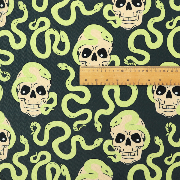 A dark charcoal pattern featuring glowing light green snakes slithering around and coiling through off-white human skulls.