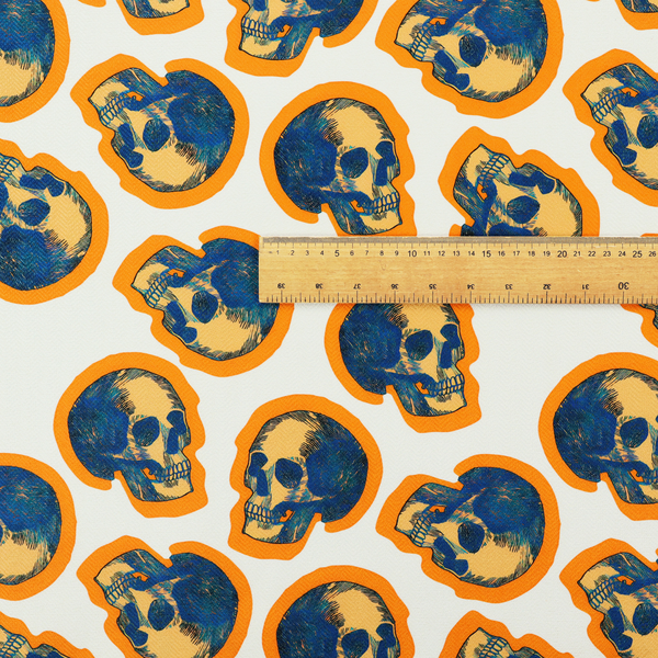 A repeating pattern on an off-white background featuring distressed blue and yellow human skulls outlined in bright orange.