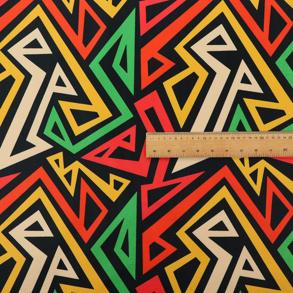 A repeating geometric fabric pattern on a black background featuring interlocking angular lines in red, yellow, green, and beige.