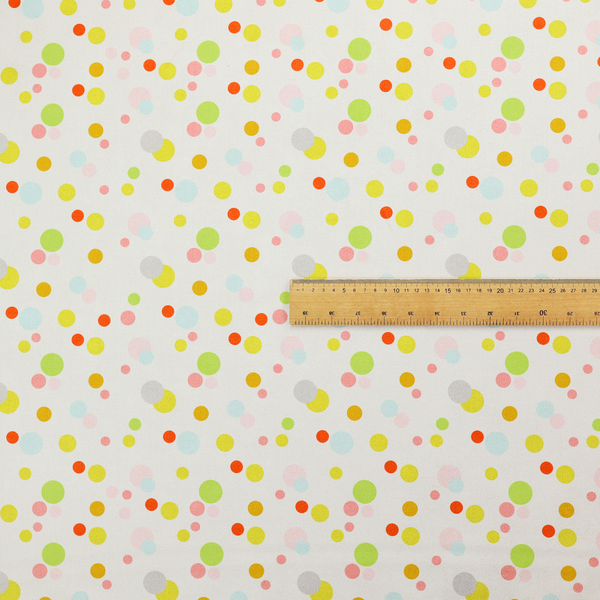 A subtle fabric pattern featuring scattered pastel and bright polka dots in shades of yellow, orange, light green, grey, and soft blue on a white background.