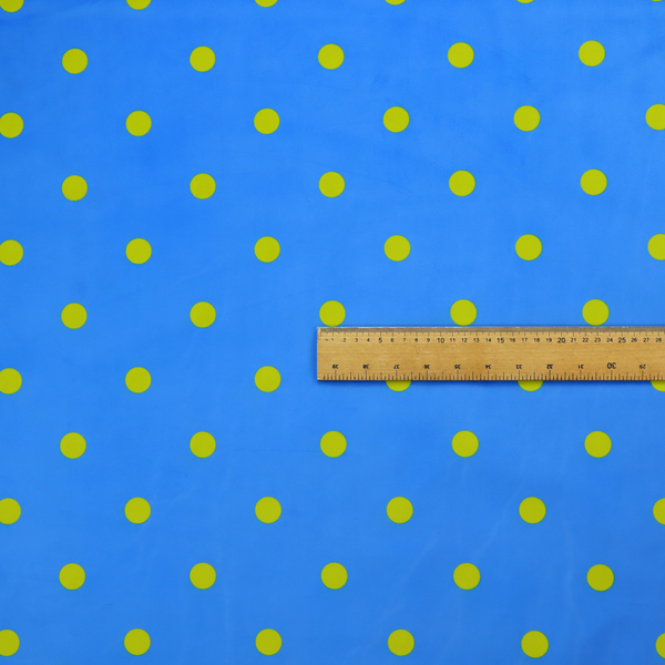 A blue fabric pattern featuring evenly spaced yellow polka dots arranged in horizontal and vertical rows.