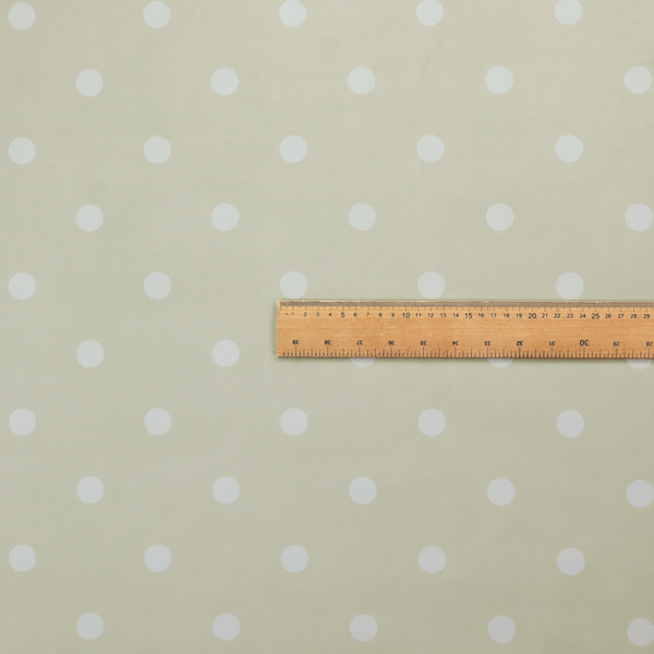 A cream or beige fabric pattern featuring evenly spaced white polka dots arranged in horizontal and vertical rows.