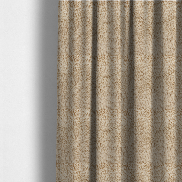 The fabric used to create these made-to-measure curtains is a tan or light beige, high-pile faux fur fabric. It has a dense, plush, and cosy texture with soft, slightly tousled fibres that create a shag-like appearance.