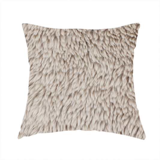 The fabric used to create this handmade cushion is a taupe or light greyish-brown, high-pile faux fur fabric. It features a dense, plush texture with soft, tousled fibres that create a cosy, shag-like appearance.