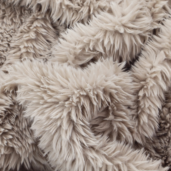 A taupe or light greyish-brown, high-pile faux fur fabric. It features a dense, plush texture with soft, tousled fibres that create a cosy, shag-like appearance.