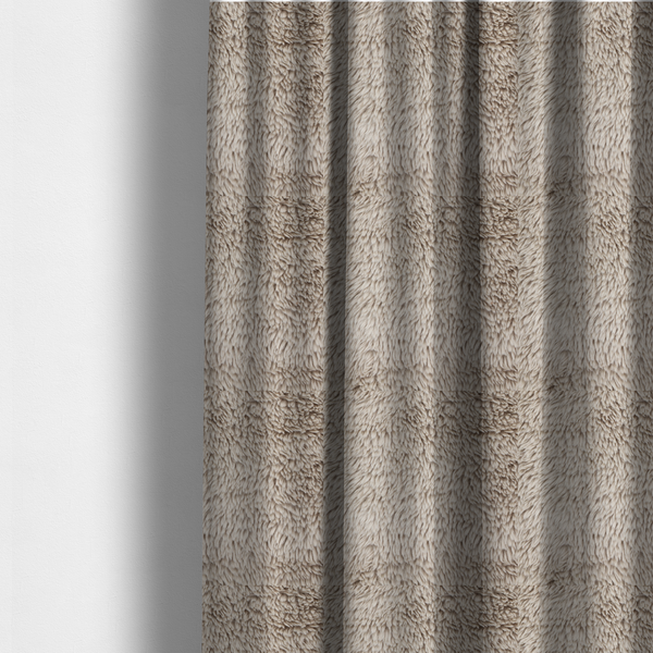 The fabric used to create these made-to-measure curtains is a taupe or light greyish-brown, high-pile faux fur fabric. It features a dense, plush texture with soft, tousled fibres that create a cosy, shag-like appearance.