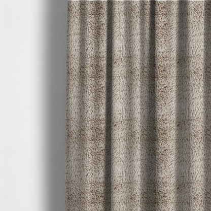 The fabric used to create these made-to-measure curtains is a taupe or light greyish-brown, high-pile faux fur fabric. It features a dense, plush texture with soft, tousled fibres that create a cosy, shag-like appearance.