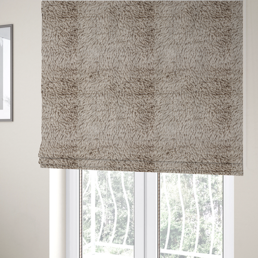 The fabric used to create these Roman blinds is a taupe or light greyish-brown, high-pile faux fur fabric. It features a dense, plush texture with soft, tousled fibres that create a cosy, shag-like appearance.