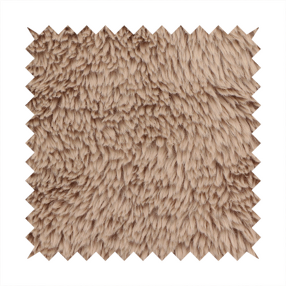 A warm beige or sandy-toned, high-pile faux fur fabric. It displays a dense, luxurious texture with soft, tousled fibres that create a cosy, shag-inspired look.