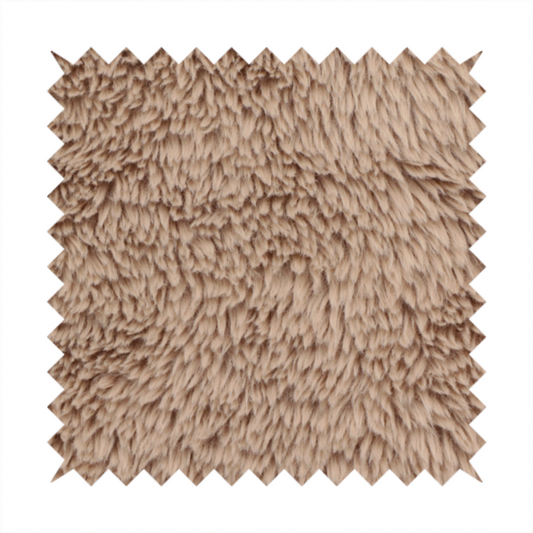 A warm beige or sandy-toned, high-pile faux fur fabric. It displays a dense, luxurious texture with soft, tousled fibres that create a cosy, shag-inspired look.