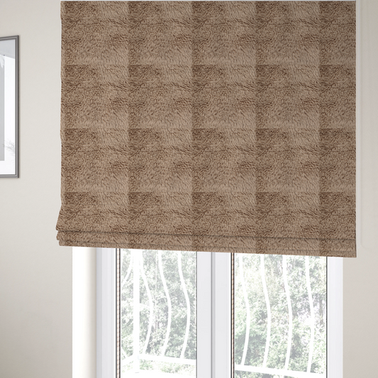 The fabric used to create these Roman blinds is a warm beige or sandy-toned, high-pile faux fur fabric. It displays a dense, luxurious texture with soft, tousled fibres that create a cosy, shag-inspired look.