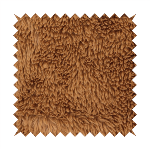 A rich, warm brown, high-pile faux fur fabric. It features a dense, luxurious texture with soft, tousled fibres that create a cosy, shag-like appearance.