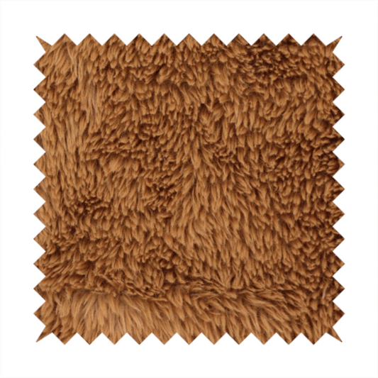 A rich, warm brown, high-pile faux fur fabric. It features a dense, luxurious texture with soft, tousled fibres that create a cosy, shag-like appearance.