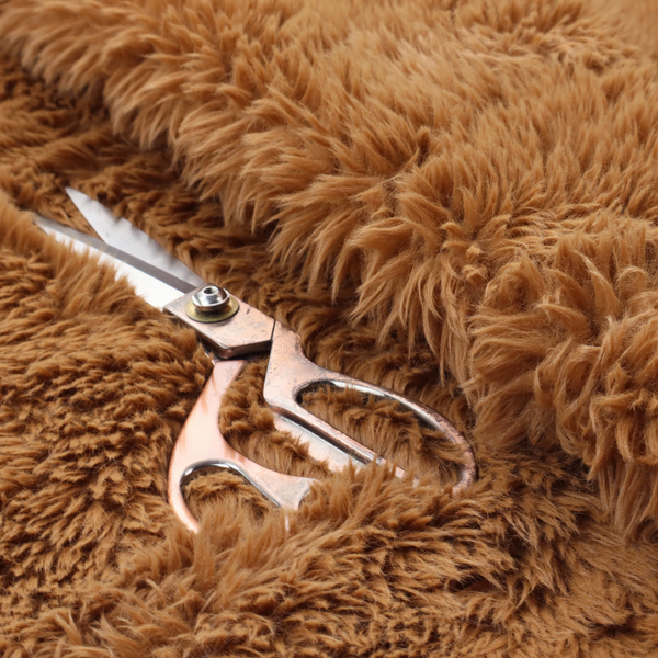 A rich, warm brown, high-pile faux fur fabric. It features a dense, luxurious texture with soft, tousled fibres that create a cosy, shag-like appearance.