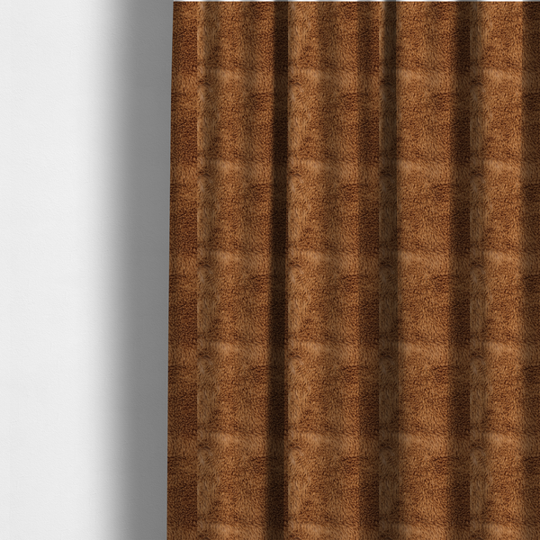 The fabric used to create these made-to-measure curtains is a rich, warm brown, high-pile faux fur fabric. It features a dense, luxurious texture with soft, tousled fibres that create a cosy, shag-like appearance.