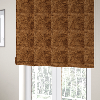 The fabric used to create these Roman blinds is a rich, warm brown, high-pile faux fur fabric. It features a dense, luxurious texture with soft, tousled fibres that create a cosy, shag-like appearance.