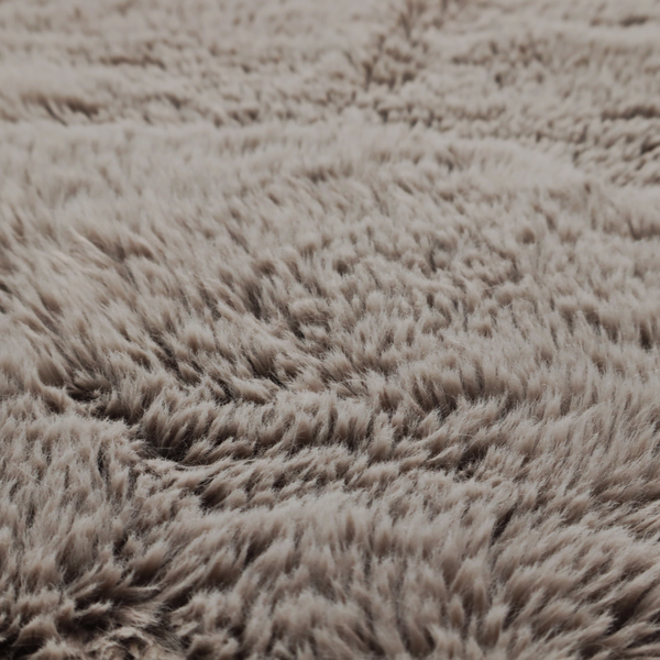 A cool-toned, greyish-brown or charcoal-taupe, high-pile faux fur fabric. It displays a dense, luxurious texture with soft, tousled fibres that create a cosy, shag-inspired look.
