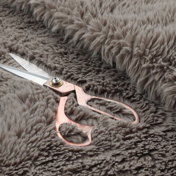 A cool-toned, greyish-brown or charcoal-taupe, high-pile faux fur fabric. It displays a dense, luxurious texture with soft, tousled fibres that create a cosy, shag-inspired look.