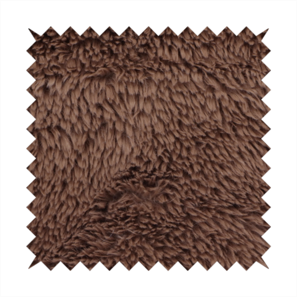 A deep, rich chocolate brown, high-pile faux fur fabric. It has a dense, luxurious texture with soft, tousled fibres that give it a warm and cosy shag-like appearance.
