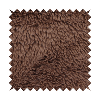 A deep, rich chocolate brown, high-pile faux fur fabric. It has a dense, luxurious texture with soft, tousled fibres that give it a warm and cosy shag-like appearance.