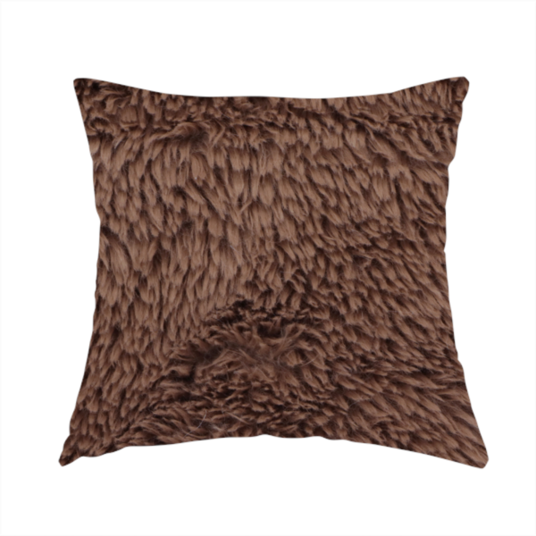 The fabric used to create this handmade cushion is a deep, rich chocolate brown, high-pile faux fur fabric. It has a dense, luxurious texture with soft, tousled fibres that give it a warm and cosy shag-like appearance.